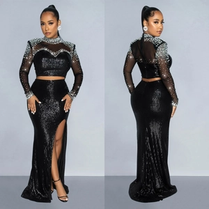 Elegant two-piece black sequined evening set with high slit skirt and beaded mesh top