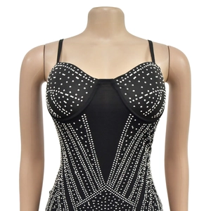 Close-up of black mesh bodysuit with silver rhinestones in a geometric pattern