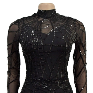 Detail of sheer black mesh top with shimmering sequins in a geometric web pattern