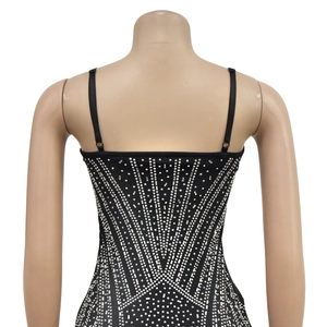 Detail of elegant black bodycon dress featuring intricate silver rhinestone geometric patterns