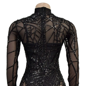 Detail of black mesh long sleeve bodysuit with intricate sequin patterns on the back