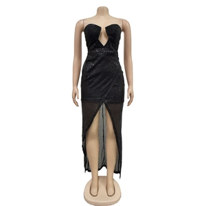 Detail of black sequined party dress featuring deep V-neckline and sheer mesh hemline