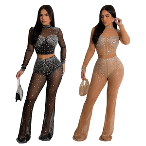 Detail of sheer mesh crop top and flared pants set with shimmering rhinestones