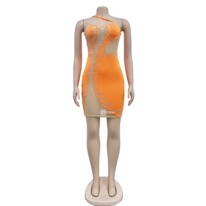 Detail of orange mesh mini dress with silver rhinestones and one-shoulder cut