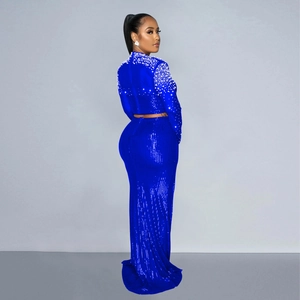 Detail of royal blue sequined two-piece evening dress with white faux pearls on sleeves