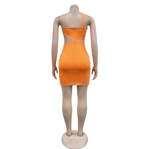Detail view of orange one-shoulder mini dress with silver rhinestones and back cutout
