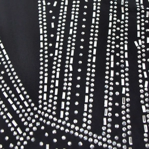 Close-up of black mesh fabric with luxury rhinestones in geometric patterns