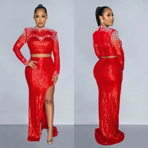 Elegant red two-piece sequin evening gown featuring sheer mesh beadwork and high slit skirt