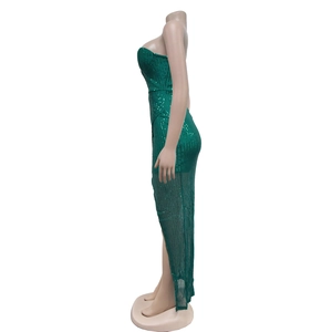 Detail of sequined dark green evening dress featuring high slit and sheer mesh fabric