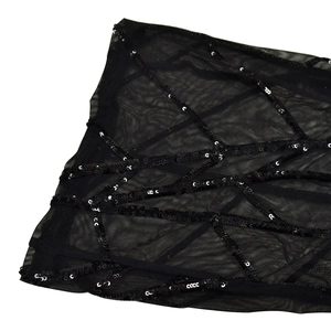Close-up of black mesh fabric featuring intricate sequin geometric patterns and textures