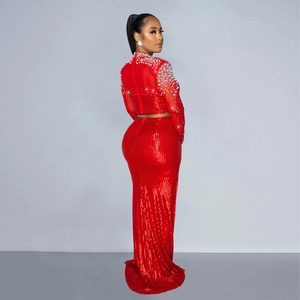 Detail of red two-piece evening dress with shimmering sequins and white beadwork embroidery