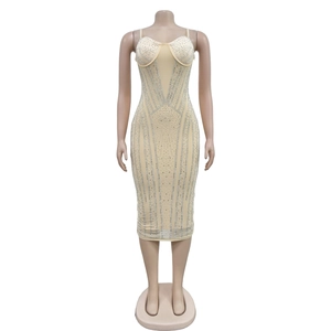 Detail of nude mesh bodycon dress with sparkling silver rhinestones in radial patterns