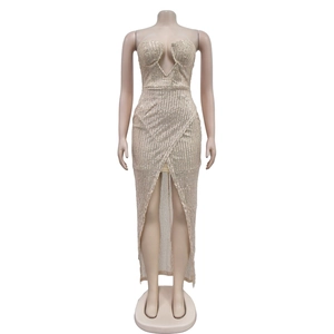 Detail of champagne gold sequined dress showing V-neckline and shiny textured fabric
