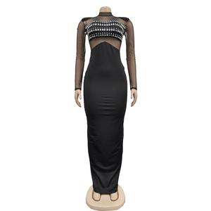 Detail view of the black mesh neckline and sparkling silver rhinestones on the long dress