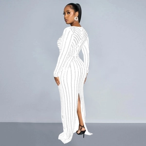 Close-up of white evening dress featuring vertical textured stripes and high back slit