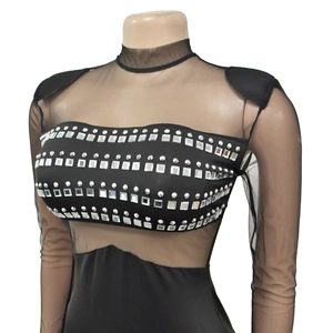 Detail of sheer mesh neckline and sleeves with sparkling rhinestone embellishments