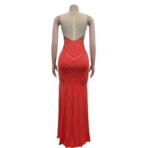Détail d'une robe de soirée rouge avec dos en mesh transparent et motifs de strass argentés