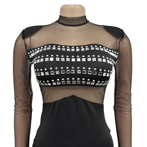 Detail of black mesh sleeves and sparkling rhinestone bodice on fashion dress