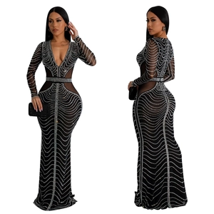Detail of black long sleeve evening gown featuring silver rhinestones and mesh panels