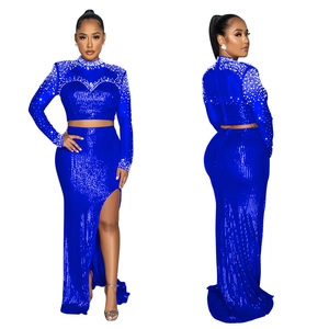 Close-up of royal blue sequin evening set with pearl beaded neckline and high-slit long skirt