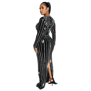 Detail of black slim-fit evening gown with vertical silver sequins and back slit