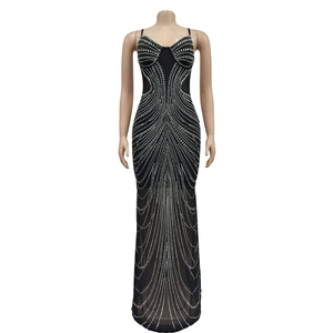 Detail of silver rhinestones in radial patterns on a black mesh sleeveless long dress