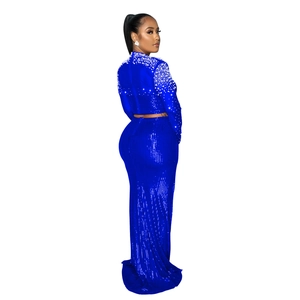 Detailed close-up of royal blue sequin evening gown with pearl shoulder embellishments