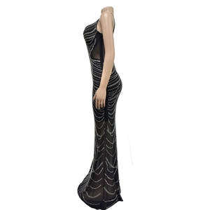Detailed side view of black fishtail dress with mesh cutout and sparkling rhinestones
