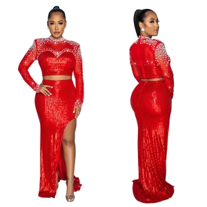 Detail of red sequin evening set with pearl embellishments and high slit long skirt