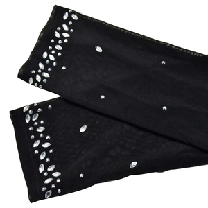 Detailed close-up of sheer black mesh sleeves featuring sparkling silver rhinestones