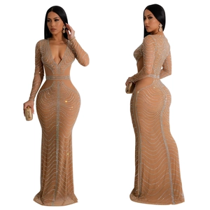 Detailed view of nude mesh evening gown featuring silver rhinestones in wave patterns