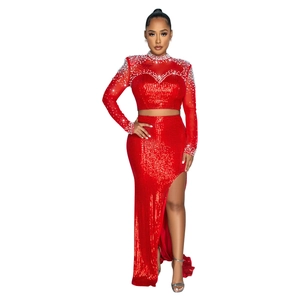 Detailed view of red sequin crop top and high slit skirt with rhinestone neckline
