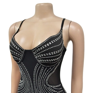 Detail of black corset with silver rhinestone wave pattern and sheer mesh panels