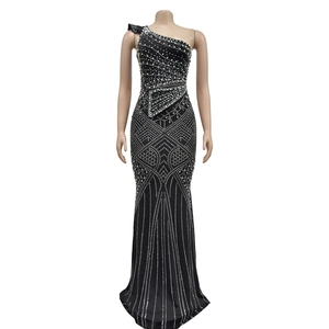 Detail of black one-shoulder dress with sparkling rhinestones and fishtail hem