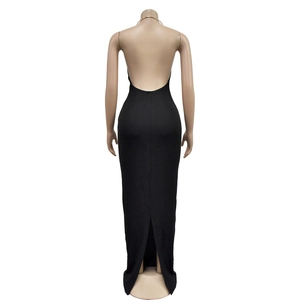 Back view of a backless black halter maxi dress with a slit and slim-fit knitted design