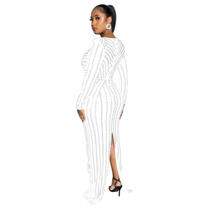 Detail of white sequin dress featuring a high back slit and elegant vertical patterns