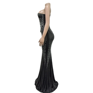 Detail of black mermaid dress featuring intricate vertical sequins and white bead patterns