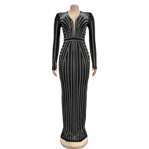 Close-up of black slit dress showing geometric silver stud patterns and sheer mesh V-neck