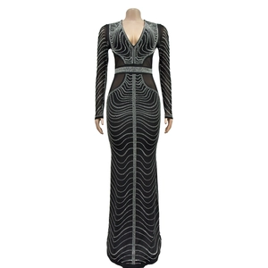Detail of black mesh long-sleeve dress featuring elegant silver rhinestones and sheer mesh inserts