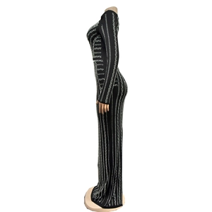 Close-up of the elegant rhinestone stripe texture on a slim-fit black long sleeve dress