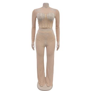 Detail of nude mesh two-piece set featuring shimmering rhinestones and corset-style bodice
