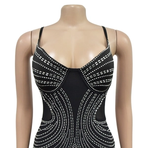 Detailed view of black rhinestone bodysuit with silver crystal stripes on corset top
