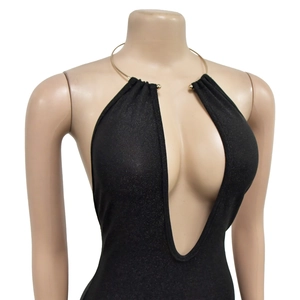 Detail of black deep V-neck dress featuring a metallic gold collar on a mannequin