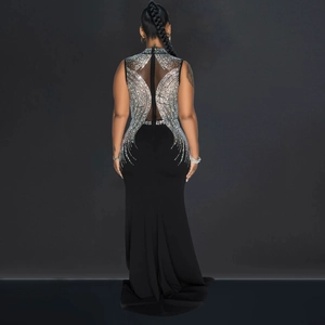 Detail of sheer mesh back with shimmering rhinestones on a slim fit black evening gown