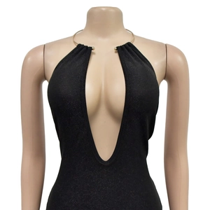 Detail of black halter maxi dress featuring deep V-neck and golden metal ring neck strap