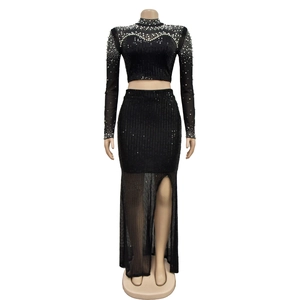 Detail of sequined mesh top and high-waist split skirt with faux pearls and glitter