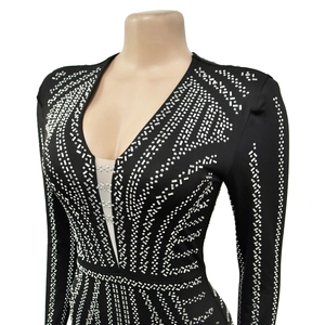 Close-up of black V-neck dress with dense silver rhinestones and mesh insert details