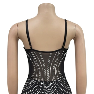 Detail of silver rhinestones in radial pattern on black mesh back of a camisole dress