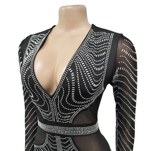 Detail of deep V-neck mesh dress with silver rhinestones and wave patterns