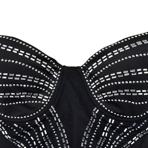 Detail view of black slim-fit bodice with intricate silver rhinestone geometric patterns